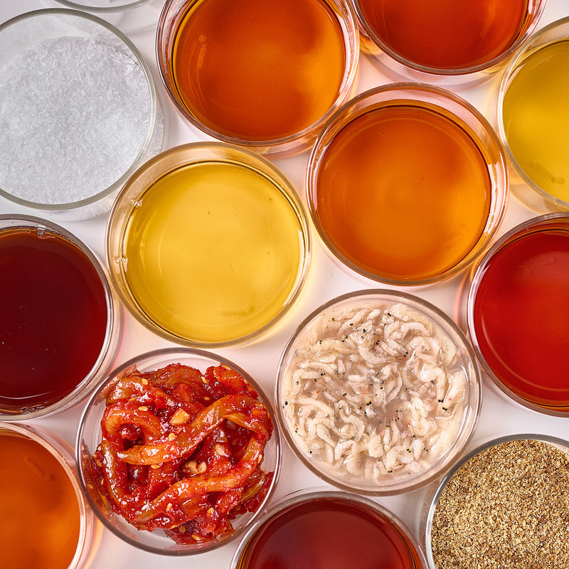 Bowls of Korean seasonings including fish sauces, salted shrimp and seasoning powders